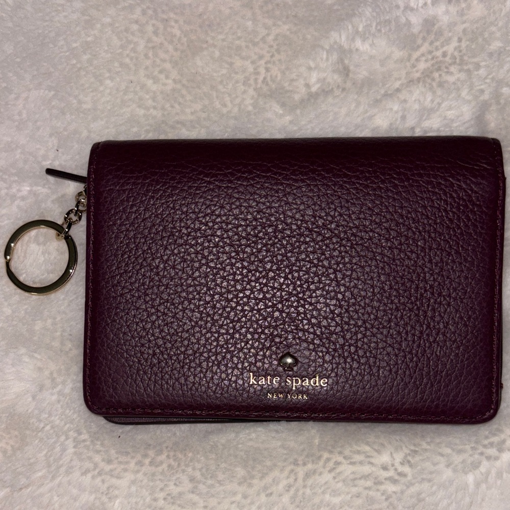 kate spade Pebbled Leather Compact Wallet in Plum